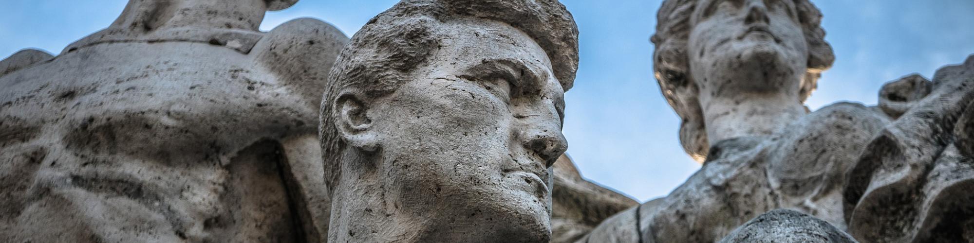 statue in italy, 2 men and 1 women