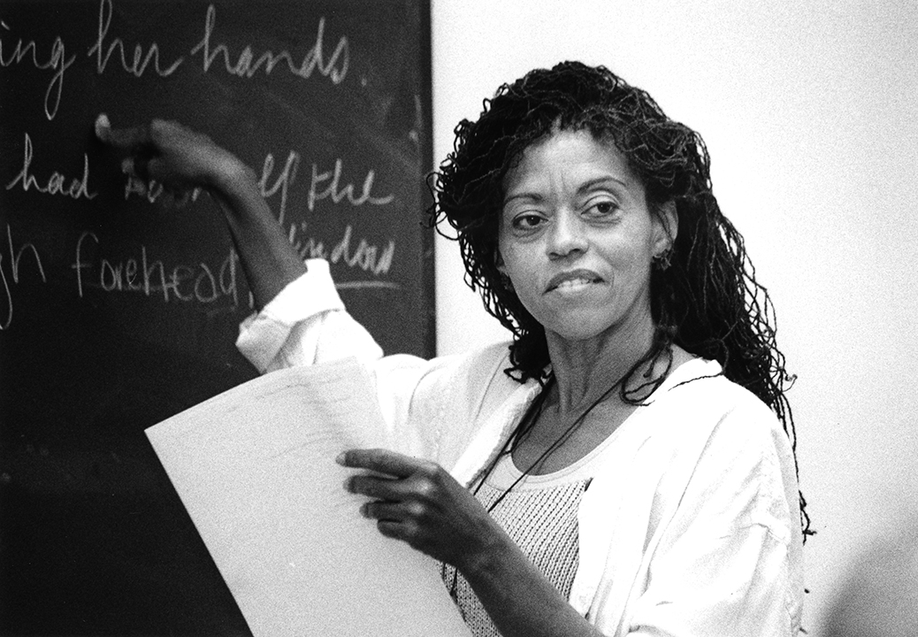 female instructor pointing to chalk board