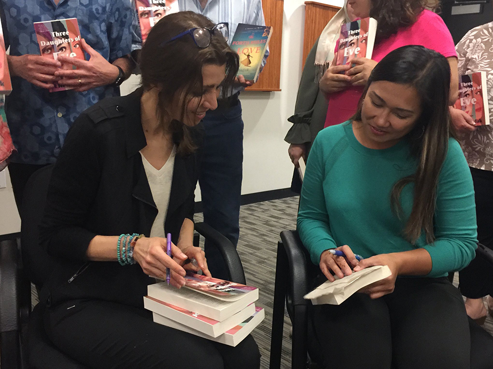 author signing book for student